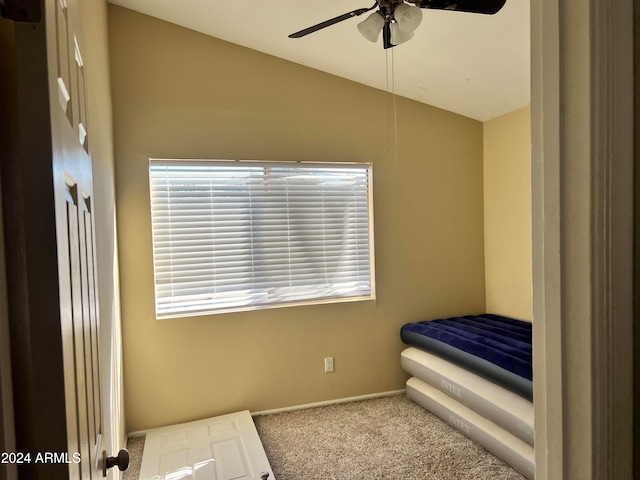 carpeted bedroom featuring ceiling fan and lofted ceiling