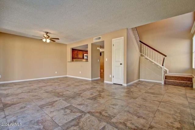 spare room with ceiling fan and a textured ceiling