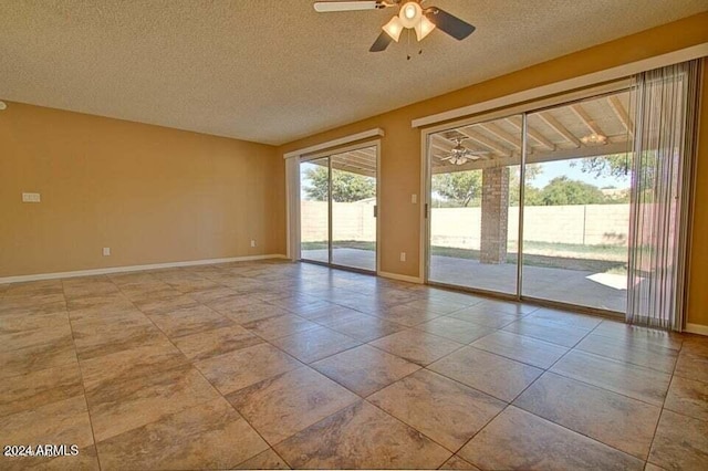 empty room featuring ceiling fan and a textured ceiling