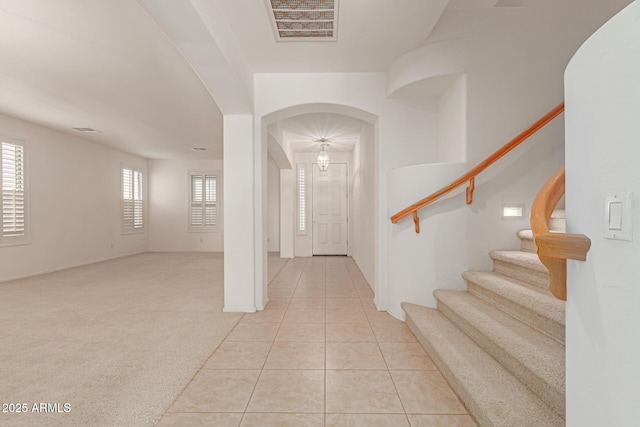 view of carpeted foyer entrance