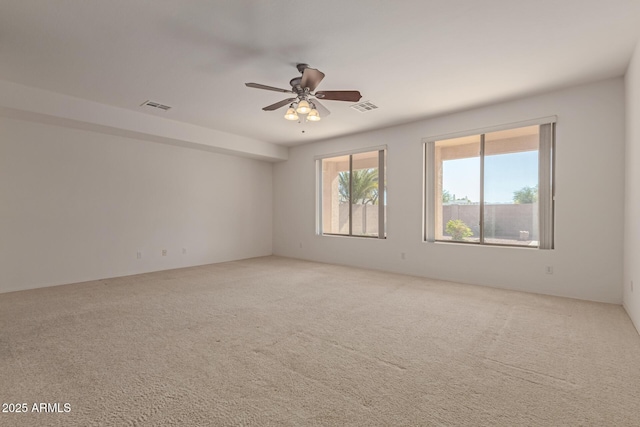 unfurnished room with ceiling fan and carpet