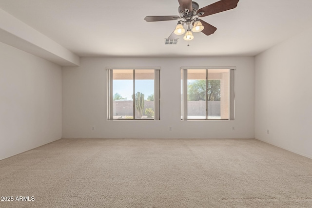 unfurnished room with ceiling fan and carpet