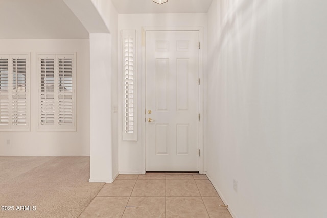 entrance foyer with light colored carpet