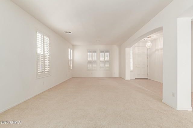 unfurnished room featuring light carpet