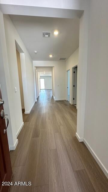 hallway with wood-type flooring