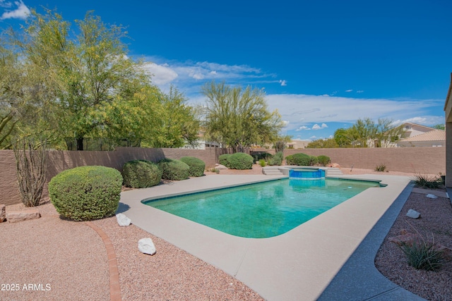 view of pool with a fenced backyard, a pool with connected hot tub, and a patio area
