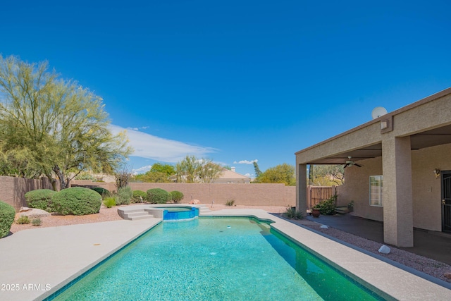 view of pool with a fenced backyard, a ceiling fan, a patio area, and a pool with connected hot tub