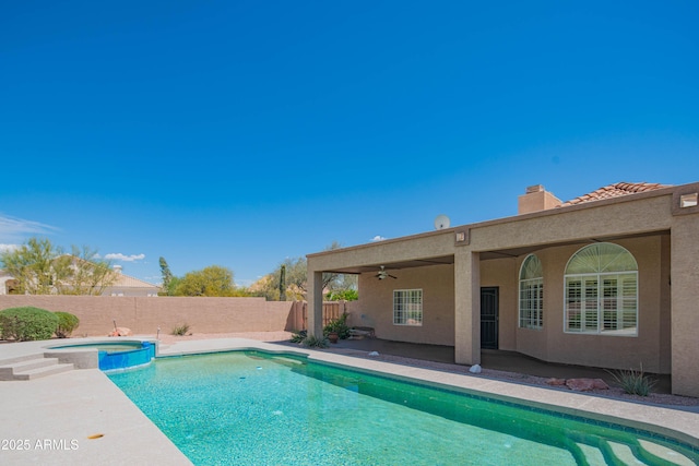 view of swimming pool featuring a fenced backyard, ceiling fan, a pool with connected hot tub, and a patio area