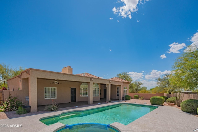 view of swimming pool featuring a fenced backyard, ceiling fan, a patio area, and a pool with connected hot tub