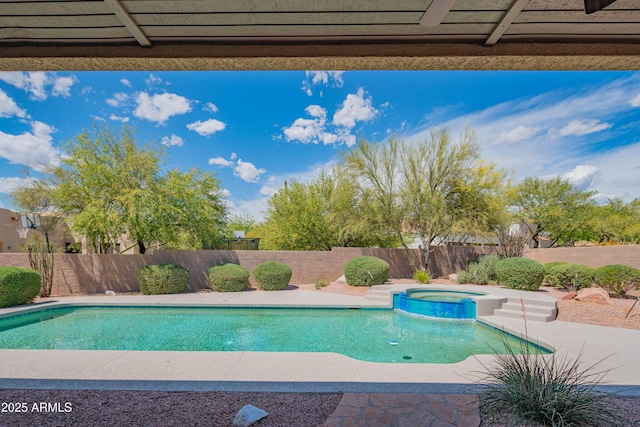 view of swimming pool featuring a pool with connected hot tub and a fenced backyard