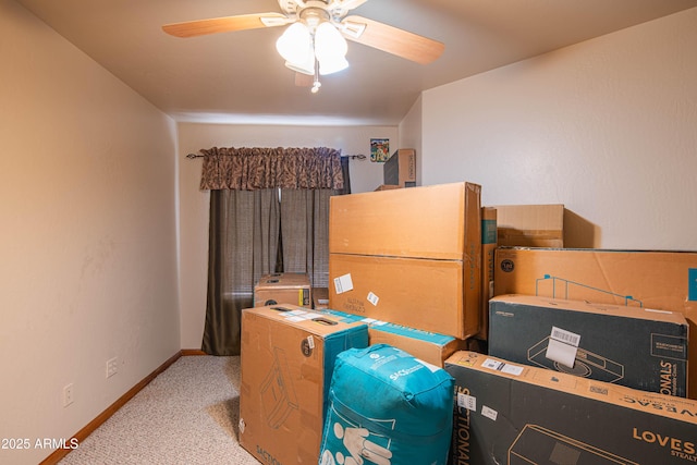 office space featuring carpet floors, baseboards, and a ceiling fan