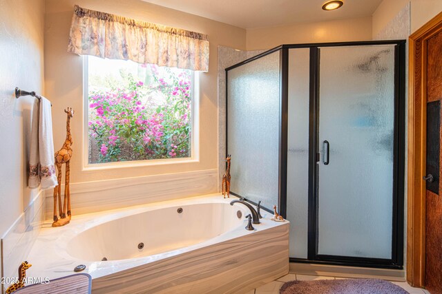 bathroom with a stall shower and a jetted tub