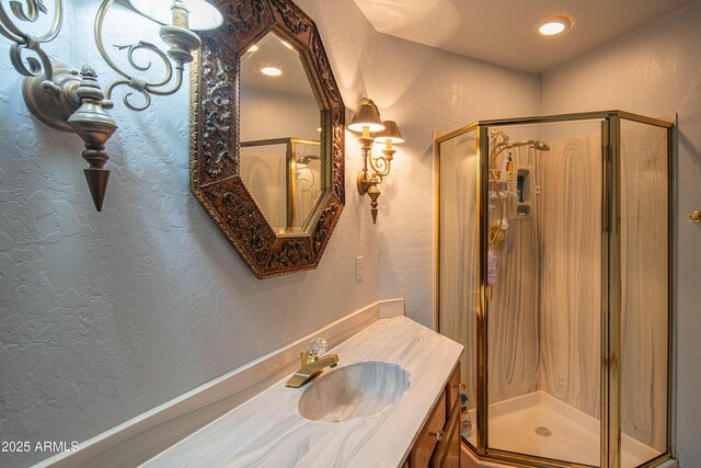 full bath featuring a textured wall and a shower stall