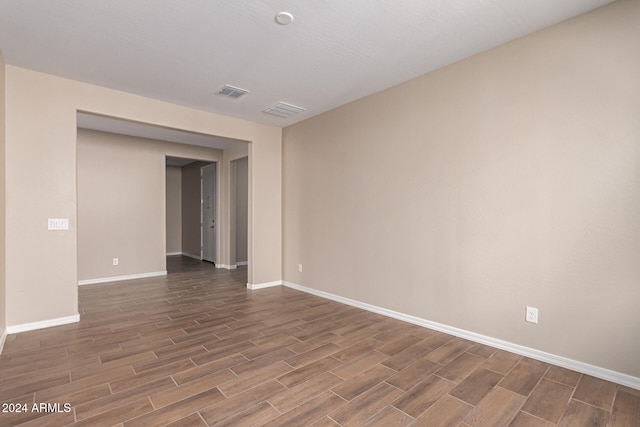 spare room featuring dark wood-type flooring