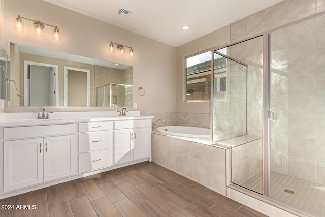 bathroom with plus walk in shower and vanity