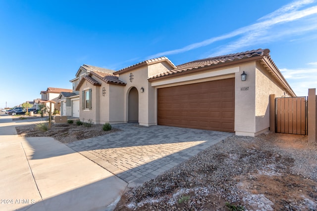 mediterranean / spanish-style home featuring a garage