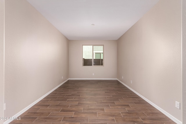 unfurnished room featuring dark wood-type flooring