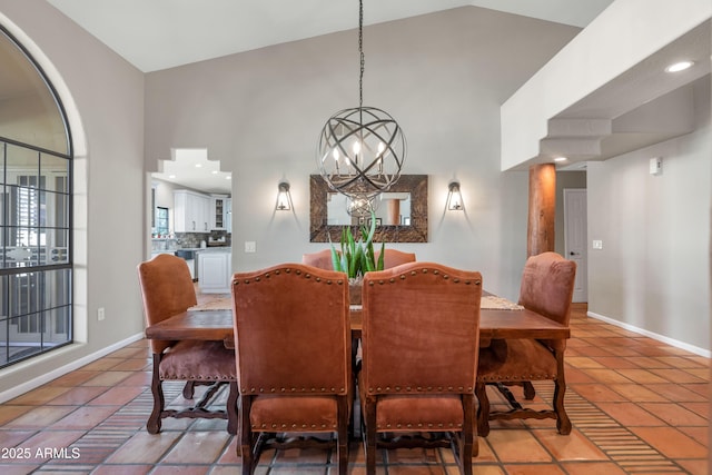 dining space with tile patterned flooring, high vaulted ceiling, and a notable chandelier