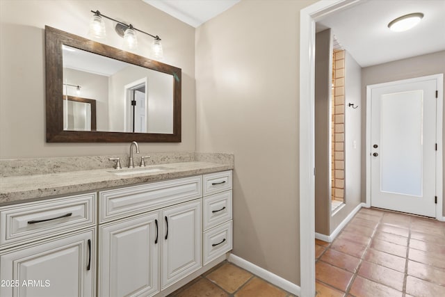 bathroom with walk in shower, vanity, and tile patterned flooring