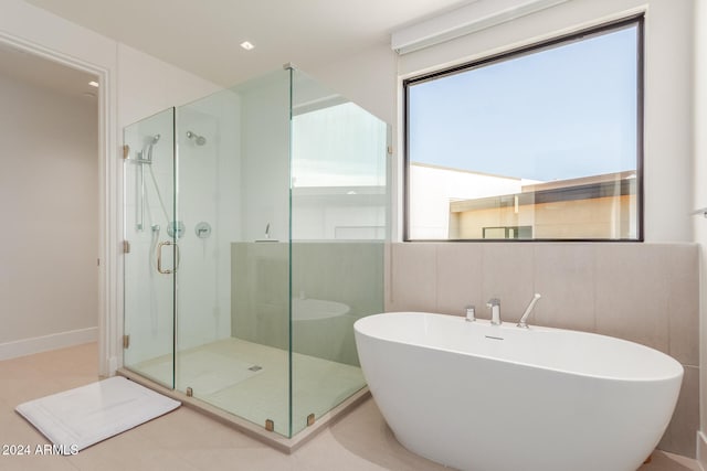 bathroom featuring plus walk in shower and tile patterned flooring