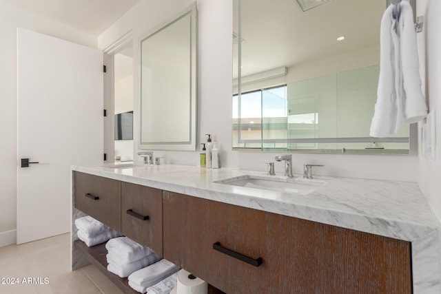 bathroom featuring tile patterned floors, vanity, and walk in shower