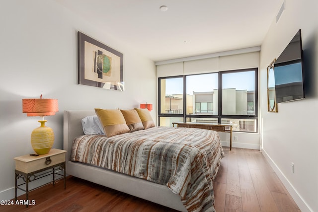 bedroom with dark hardwood / wood-style floors