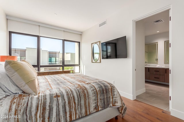 6311 E Phoenician Blvd Unit 18, Scottsdale, AZ 85251 - bedroom featuring wood finished floors, ensuite bath, and baseboards