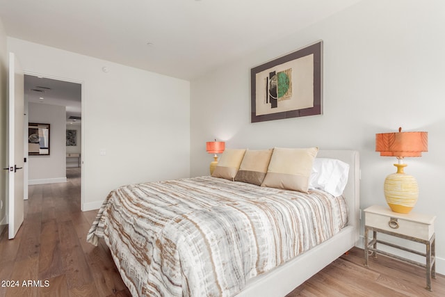 bedroom with hardwood / wood-style floors