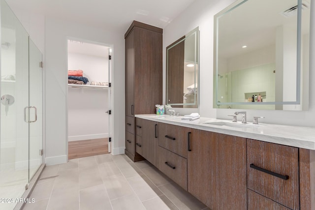 6311 E Phoenician Blvd Unit 18, Scottsdale, AZ 85251 - full bath featuring double vanity, a shower stall, a spacious closet, baseboards, and tile patterned flooring
