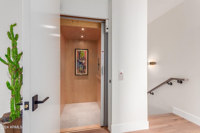 interior space featuring elevator and hardwood / wood-style floors