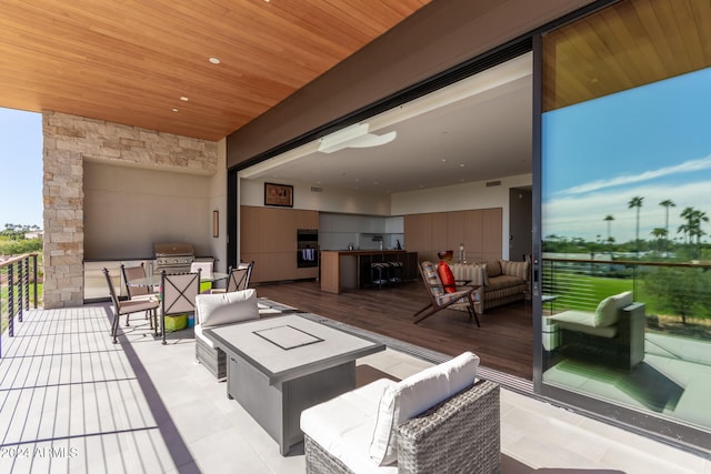 view of patio / terrace featuring an outdoor living space, area for grilling, and a balcony