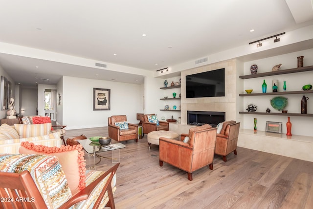 6311 E Phoenician Blvd Unit 18, Scottsdale, AZ 85251 - living area with light wood-style flooring, recessed lighting, a tiled fireplace, and built in shelves