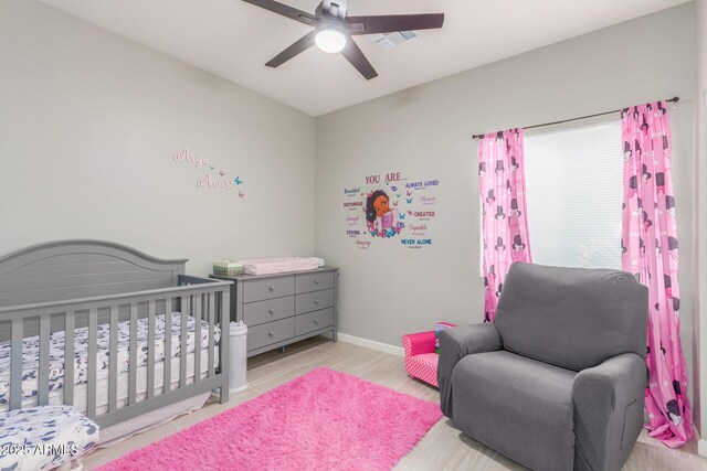 bedroom with baseboards, a ceiling fan, and wood finished floors