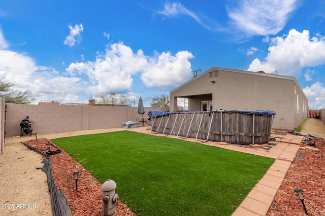 view of yard with a fenced in pool and a fenced backyard