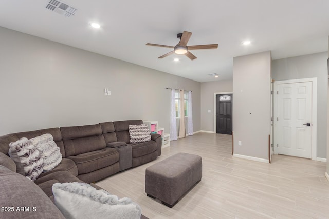 living room featuring recessed lighting, visible vents, light wood-style flooring, ceiling fan, and baseboards