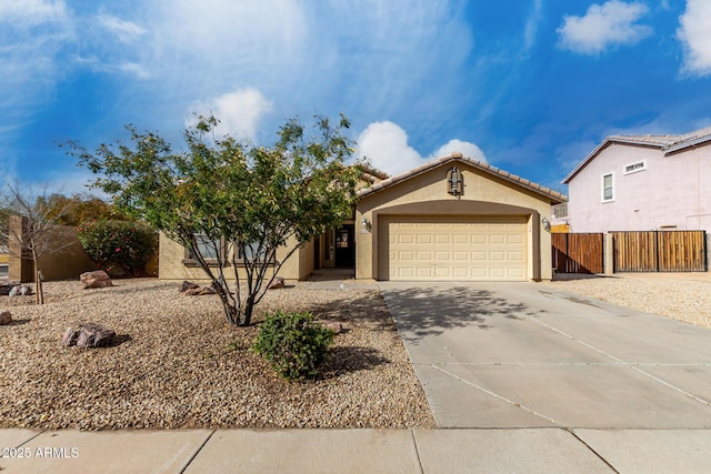 view of front of property with a garage, concrete driveway, a tiled roof, fence, and stucco siding