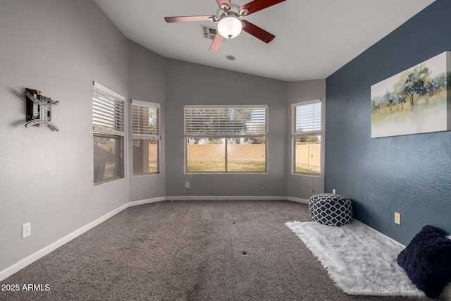 empty room with visible vents, a textured wall, carpet flooring, vaulted ceiling, and baseboards