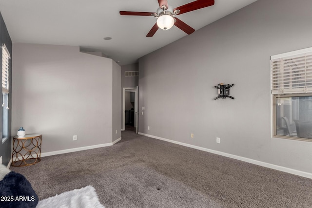 unfurnished bedroom featuring visible vents, baseboards, ceiling fan, carpet, and vaulted ceiling