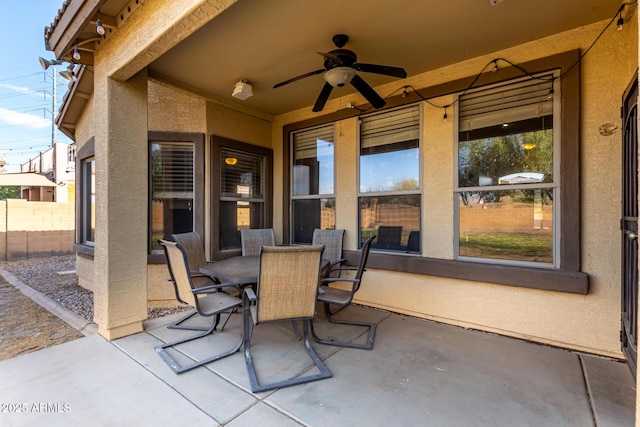 view of patio / terrace with fence, a ceiling fan, and outdoor dining space