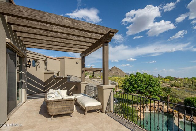 balcony with a fenced in pool, a pergola, and a mountain view