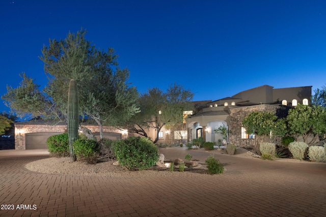 yard at twilight featuring a garage