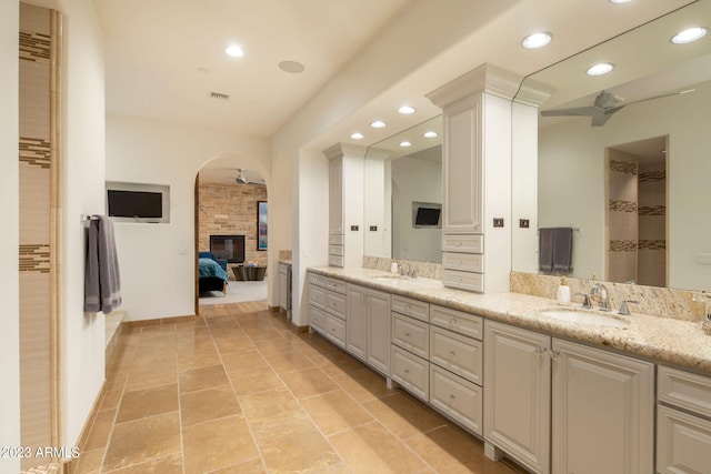 bathroom featuring double sink, oversized vanity, tile floors, and ceiling fan