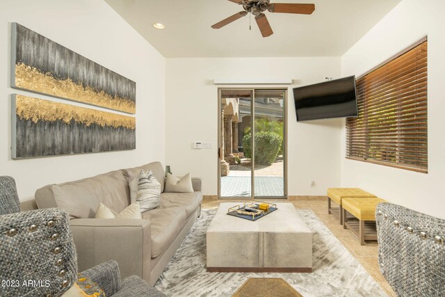 living room with light tile flooring and ceiling fan