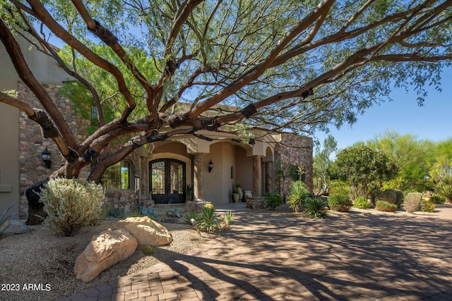 mediterranean / spanish house featuring french doors