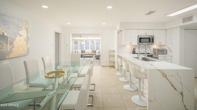 interior space with ceiling fan and light tile patterned floors