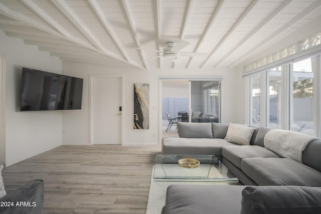 living area with ceiling fan, lofted ceiling with beams, baseboards, and wood finished floors