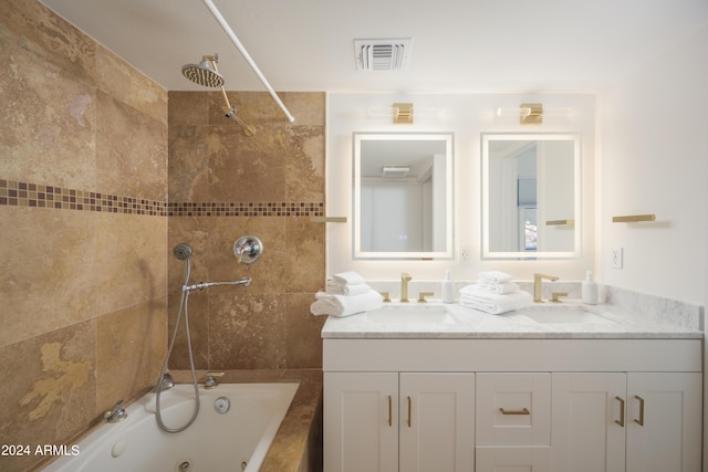 full bathroom with double vanity, a combined bath / shower with jetted tub, a sink, and visible vents