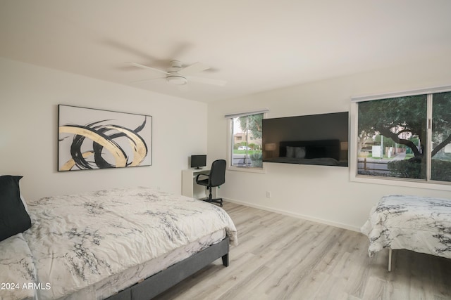 bedroom featuring ceiling fan, wood finished floors, and baseboards