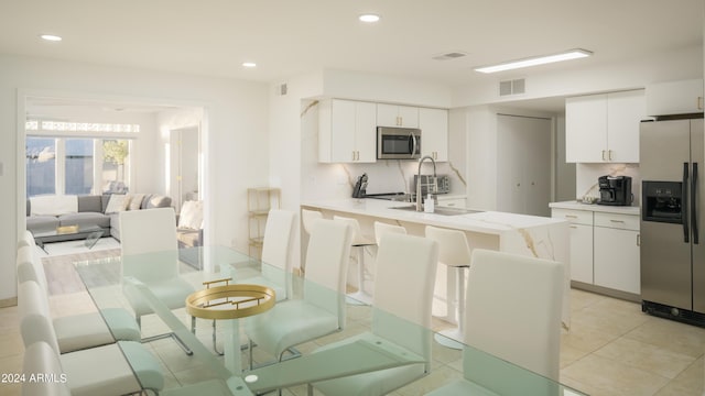 dining space featuring recessed lighting, visible vents, and light tile patterned floors