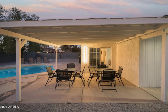 view of patio with a fenced in pool, outdoor dining space, and fence